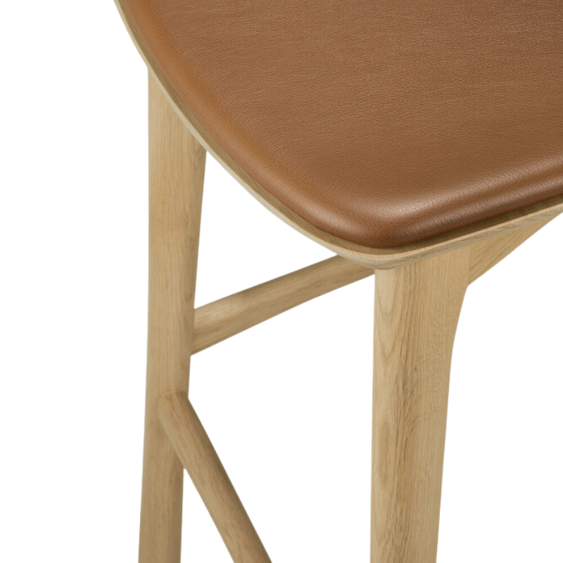 The Bok Upholstered Counter Stool from Ethnicraft is in leg and leather detail.