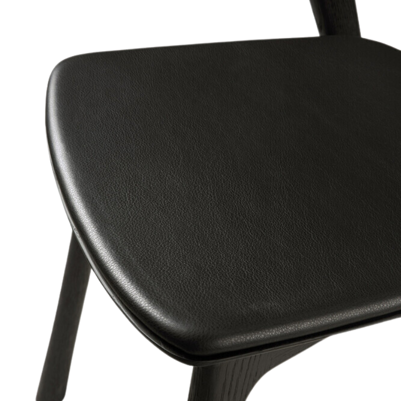 The Bok Upholstered Dining Chair from Ethnicraft in black oak with black leather seat.