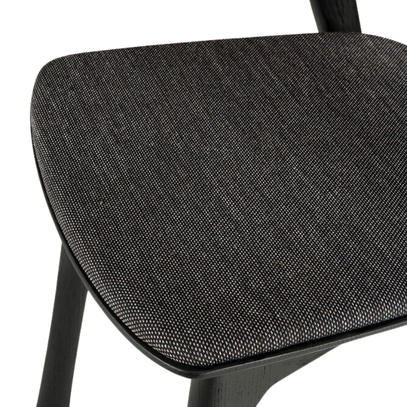 The Bok Upholstered Dining Chair from Ethnicraft in black oak with soft black fabric seat.