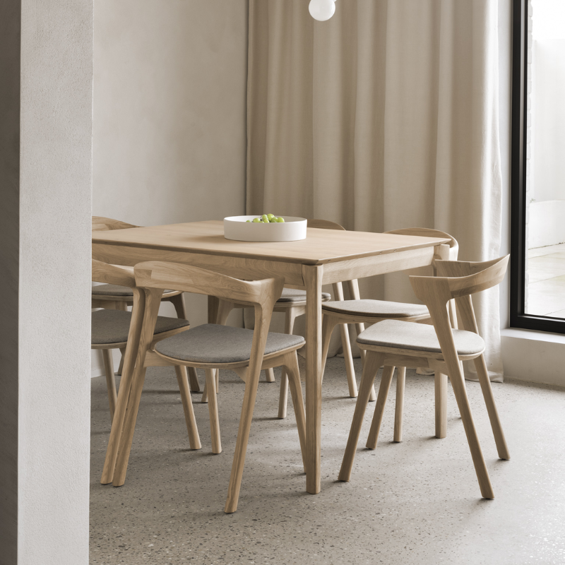 The Bok Upholstered Dining Chair from Ethnicraft with a dining table.