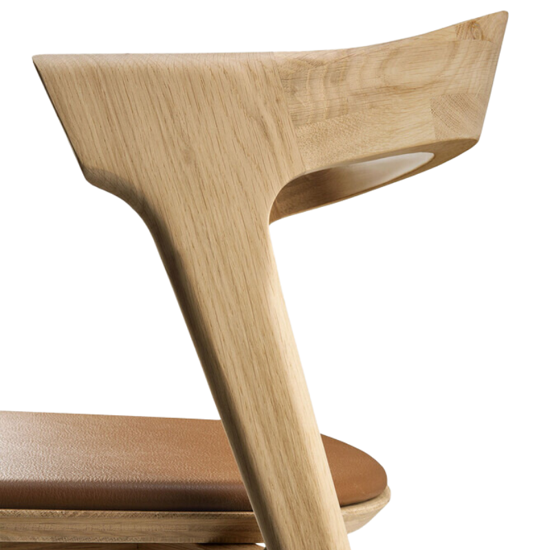 The Bok Upholstered Dining Chair from Ethnicraft in oak with cognac leather back rest.