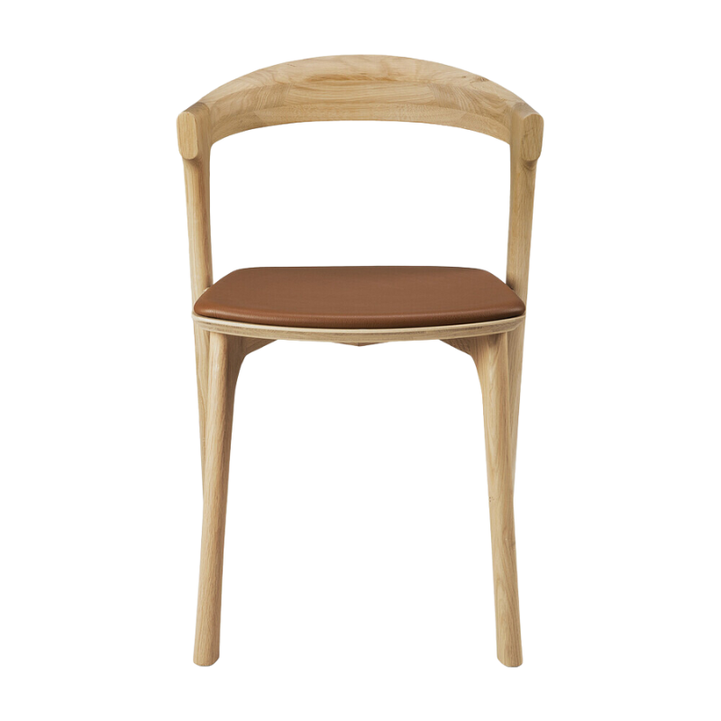 The Bok Upholstered Dining Chair from Ethnicraft in oak with cognac leather from the front.