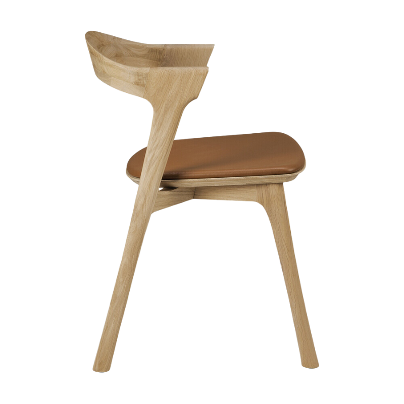 The Bok Upholstered Dining Chair from Ethnicraft in oak with cognac leather from the side.