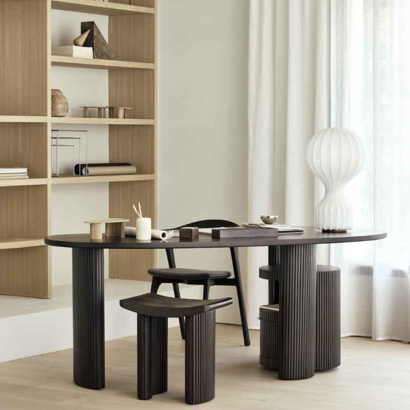 The Boomerang Desk 78.5 inches by Ethnicraft in a modern living room.