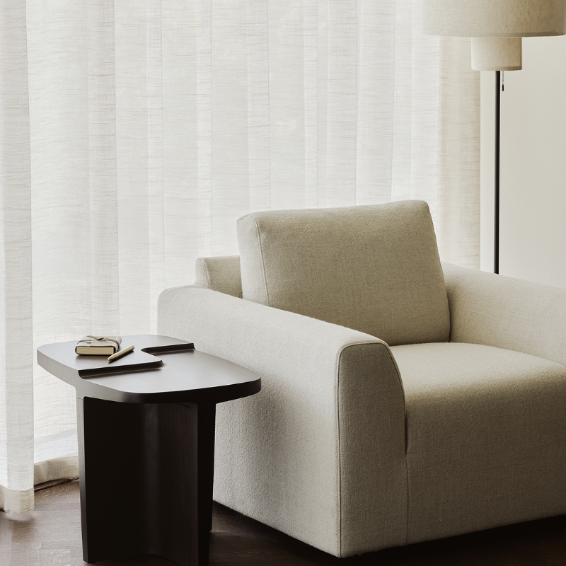 The Brutalist Rectangular Side Table by Ethnicraft in the living room with an armchair.