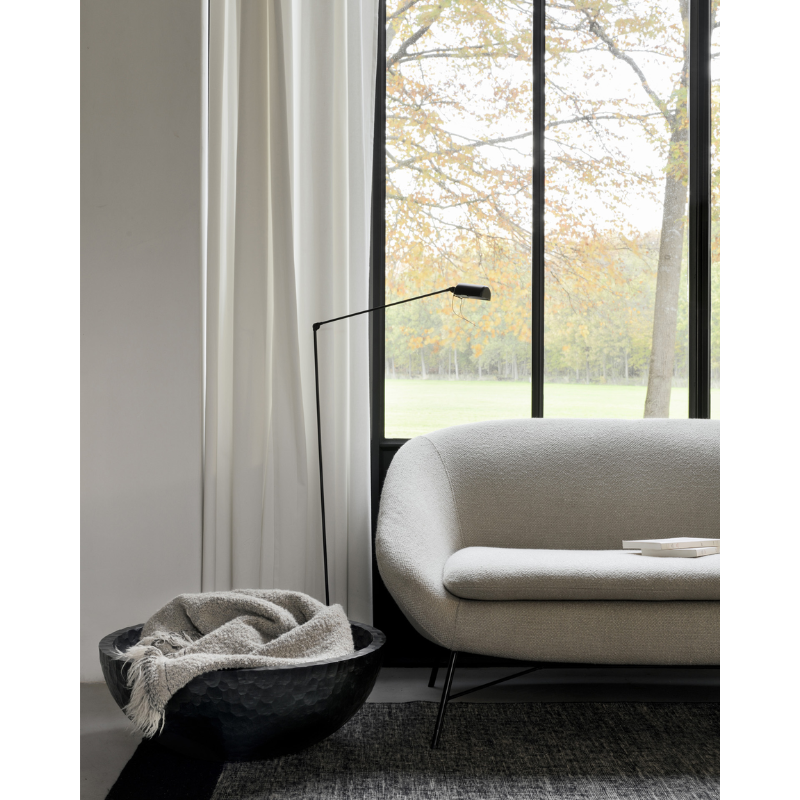 The Chopped XL Bowl from Ethnicraft in a living room, holding a throw.