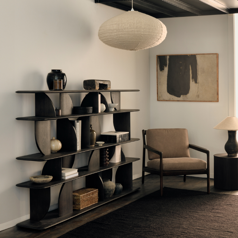 The Geometric Rack from Ethnicraft in dark brown teak in a living room.