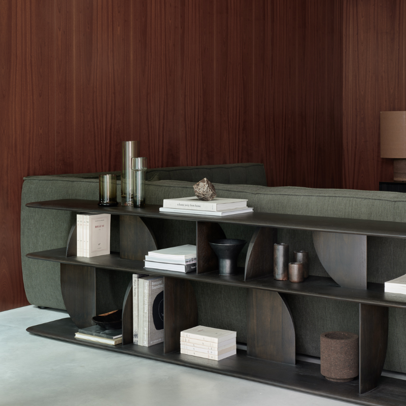 The Geometric Sofa Console from Ethnicraft in dark brown teak in a lounge.