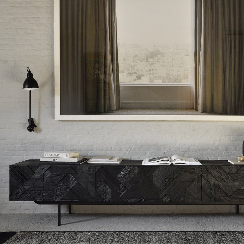 The Graphic TV Cupboard from Ethnicraft in a bedroom.