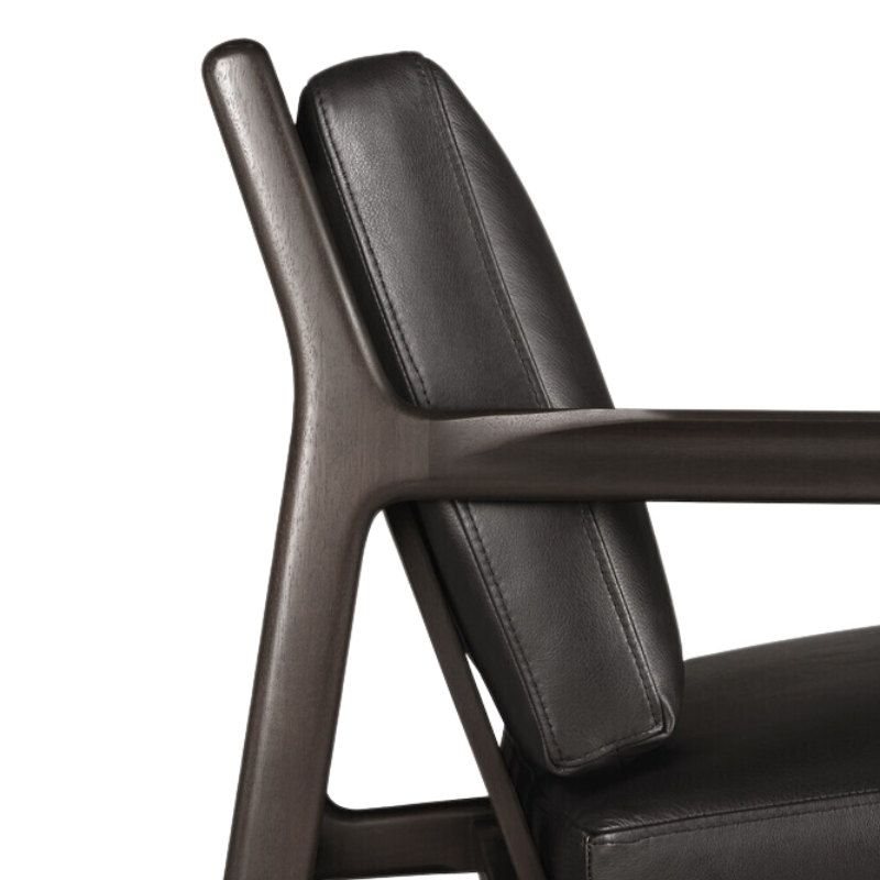 The Jack Lounge Chair from Ethnicraft with a black leather cushion highlighting the back rest.