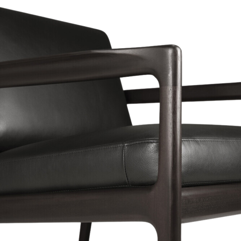 The Jack Lounge Chair from Ethnicraft with a black leather cushion close up.