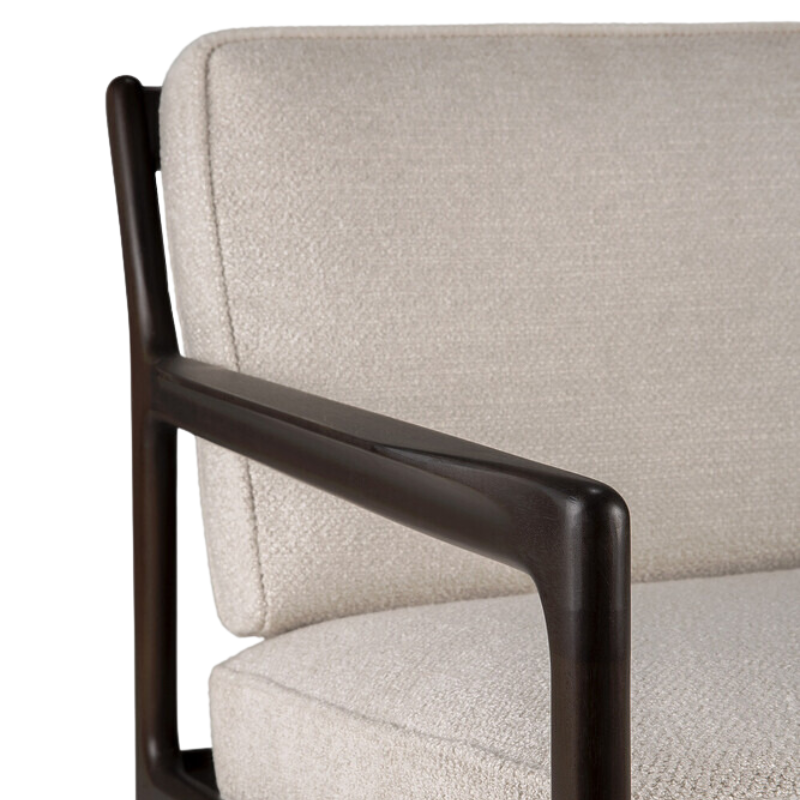 The Jack Lounge Chair from Ethnicraft with an ivory cushion focusing on the arm rest.