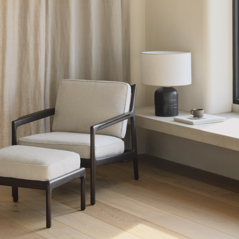 The Jack Lounge Chair from Ethnicraft with an ivory cushion in a lounge.