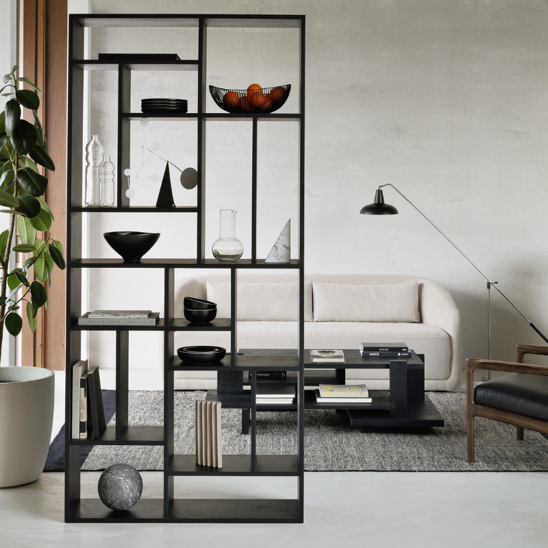 The M Rack from Ethnicraft large size in black oak in a living room.