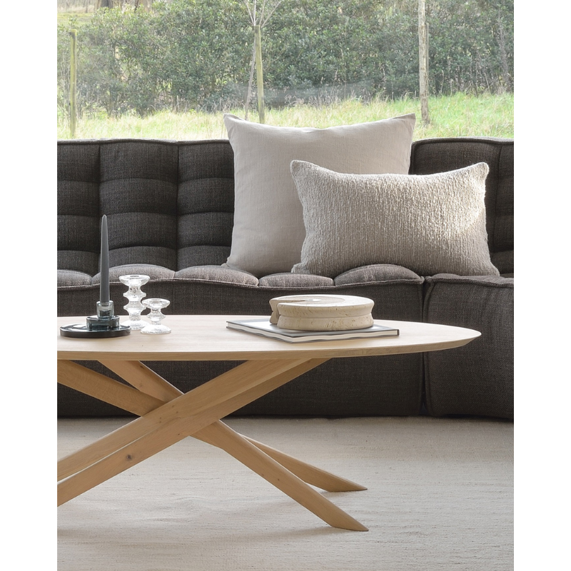 The Mikado Oval Coffee Table from Ethnicraft in a family space.