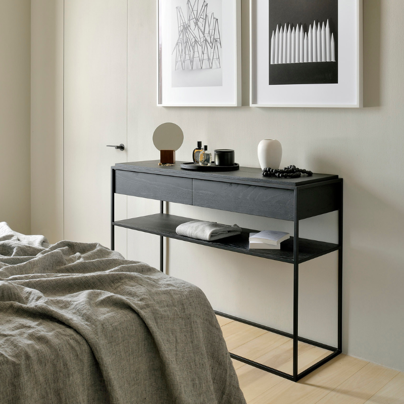 The Monolit Console from Ethnicraft in black oak in a bedroom.