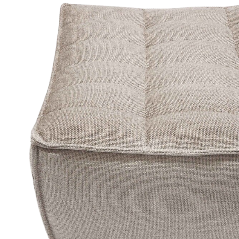 The N701 Footstool from Ethnicraft with beige standard fabric close up.