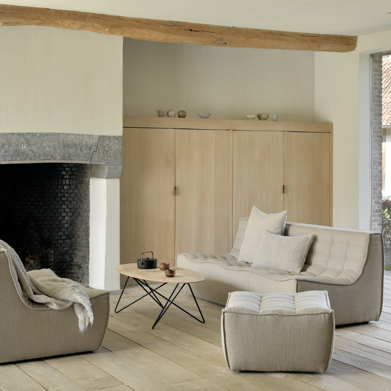 The N701 Footstool from Ethnicraft with beige standard fabric in a living room.