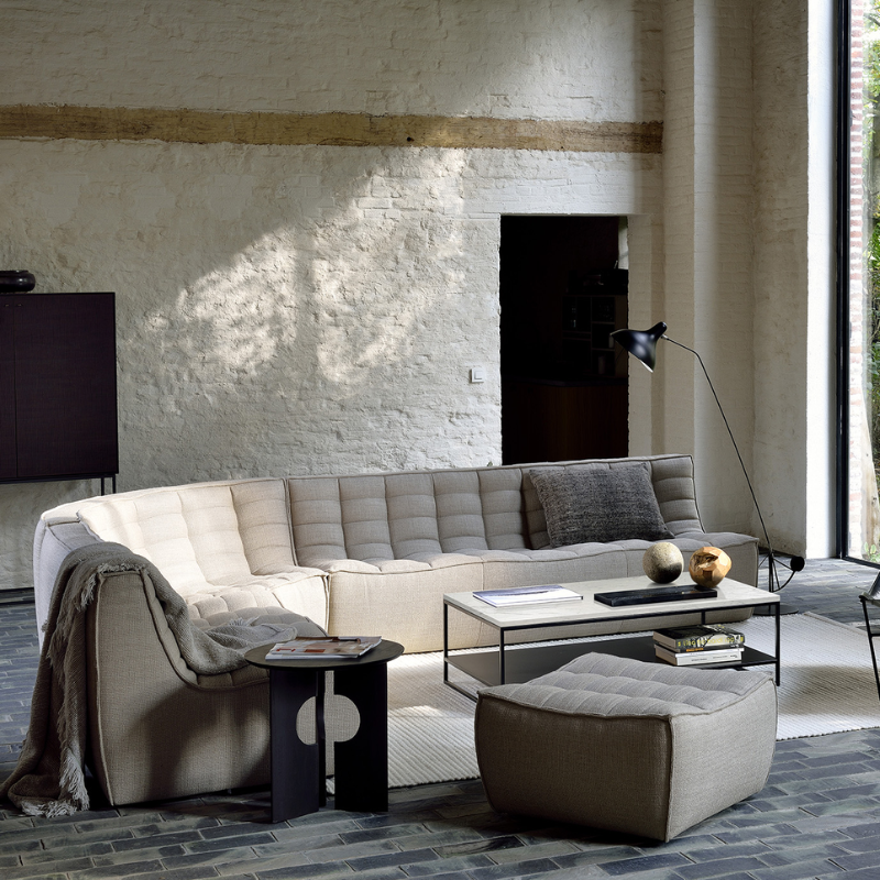 The N701 Footstool from Ethnicraft with beige standard fabric in a lounge.