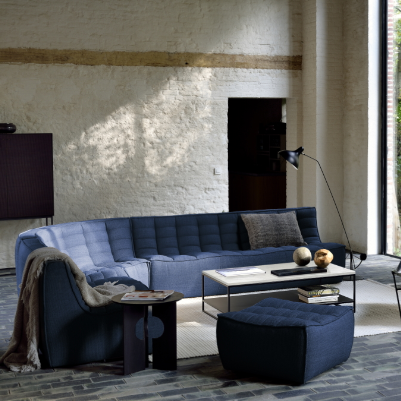 The N701 Footstool from Ethnicraft with blue standard fabric in a family area.