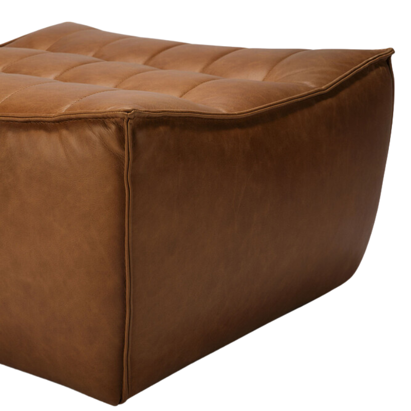 The N701 Leather Footstool from Ethnicraft focusing on the craftsmanship of the aniline leather upholstery.