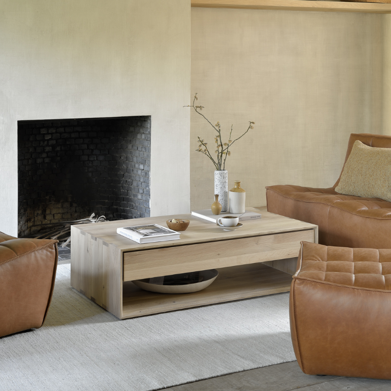The N701 Leather Footstool from Ethnicraft in a family room.