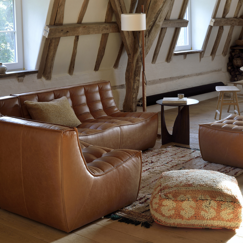 The N701 Leather Footstool from Ethnicraft in a living room.