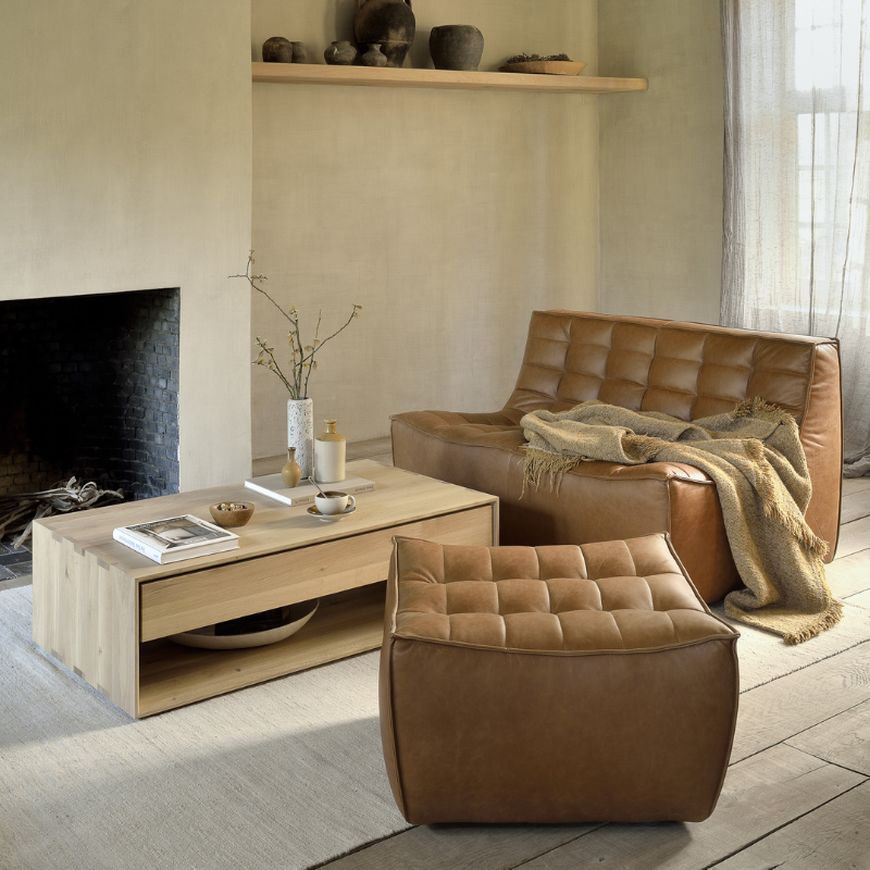 The N701 Leather Footstool from Ethnicraft in a lounge.
