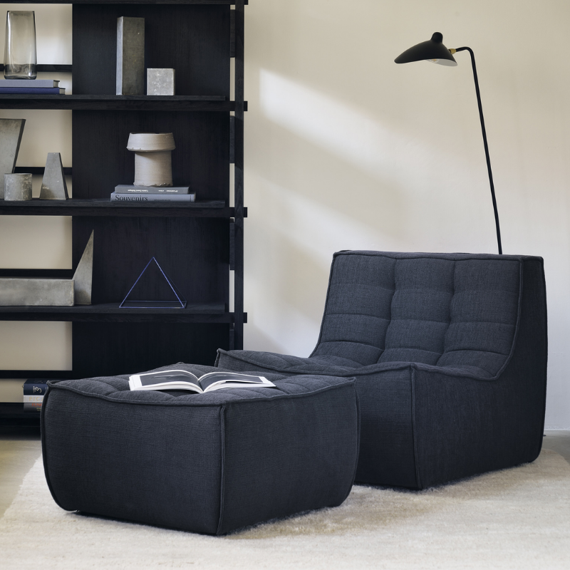 The N701 Lounge Chair and Ottoman from Ethnicraft with graphite eco fabric in a living room.