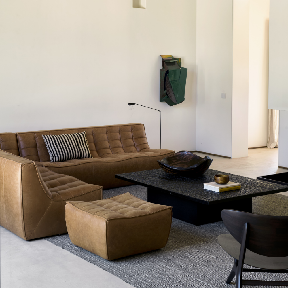 The N701 Modular Sofa from Ethnicraft with old saddle aniline leather in a den.