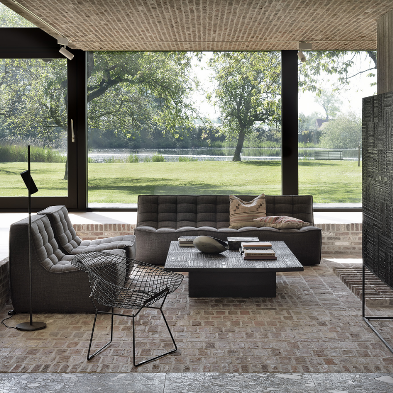 The N701 One Seater from Ethnicraft with dark grey standard fabric in a gathering room.