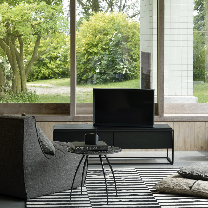 The N701 One Seater from Ethnicraft with dark grey standard fabric in a study.