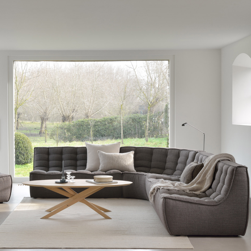 The N701 Round Corner from Ethnicraft in dark grey standard fabric in a lounge.