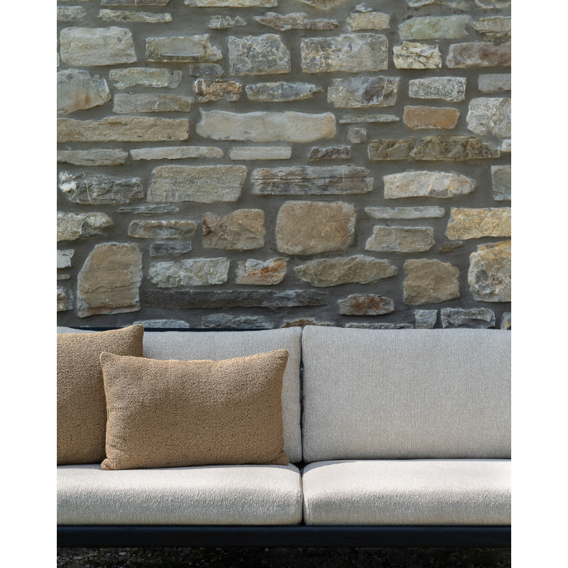 The cumin Nomad Rectangular Outdoor Cushion by Ethnicraft in an outdoor family area.