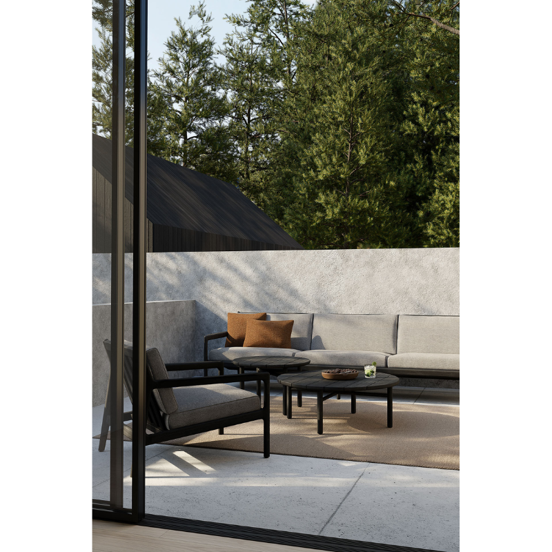 The Nomad Rectangular Outdoor Cushion by Ethnicraft in an outdoor living space.