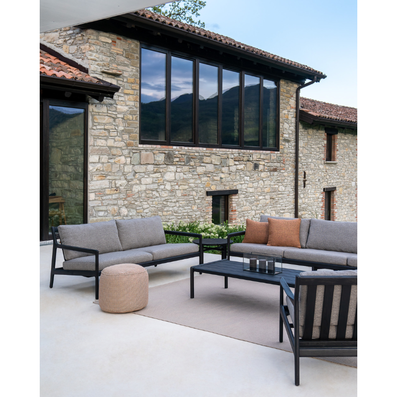 The Nomad Square Outdoor Cushion from Ethnicraft in an outdoor family space.