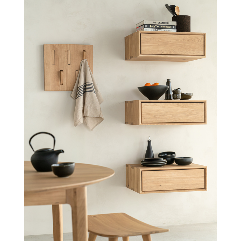 The Nordic II Hanging Bedside Table from Ethnicraft in a dining room.