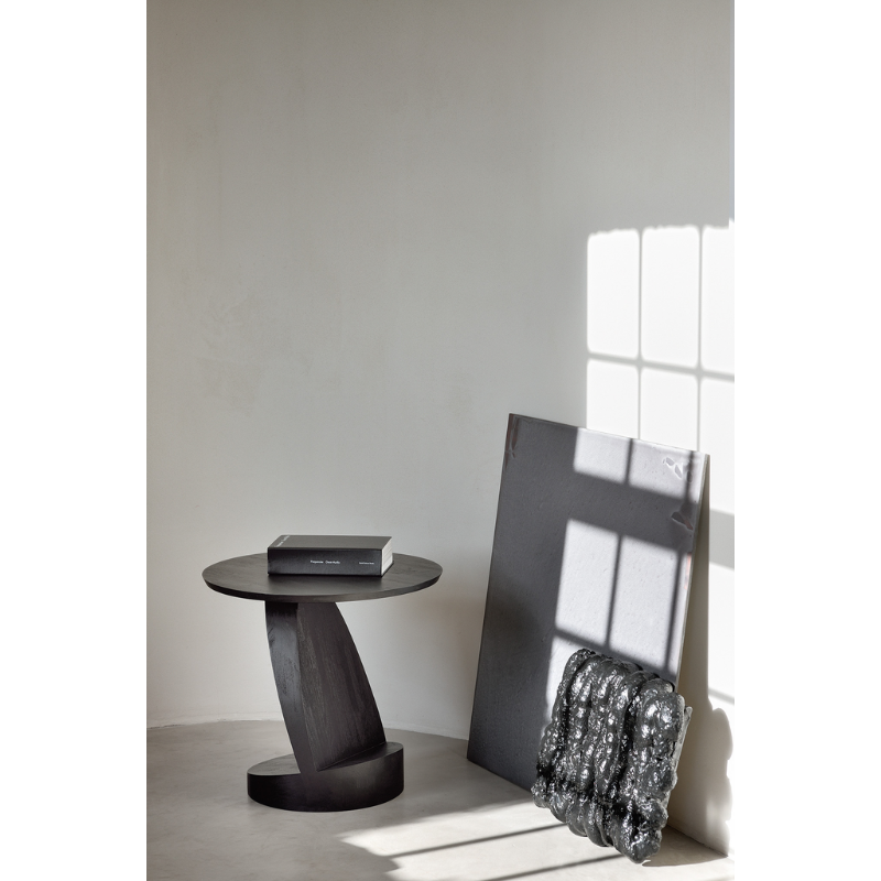 The black teak Oblic Side Table from Ethnicraft in a home office.