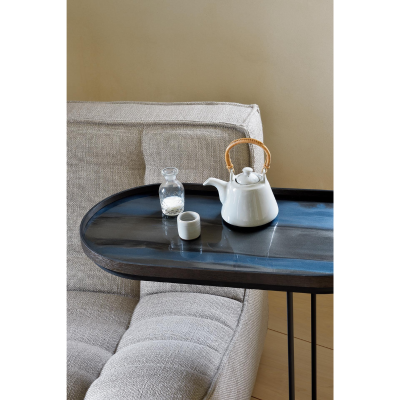 The oblong Tray Side Table from Ethnicraft in a living space.