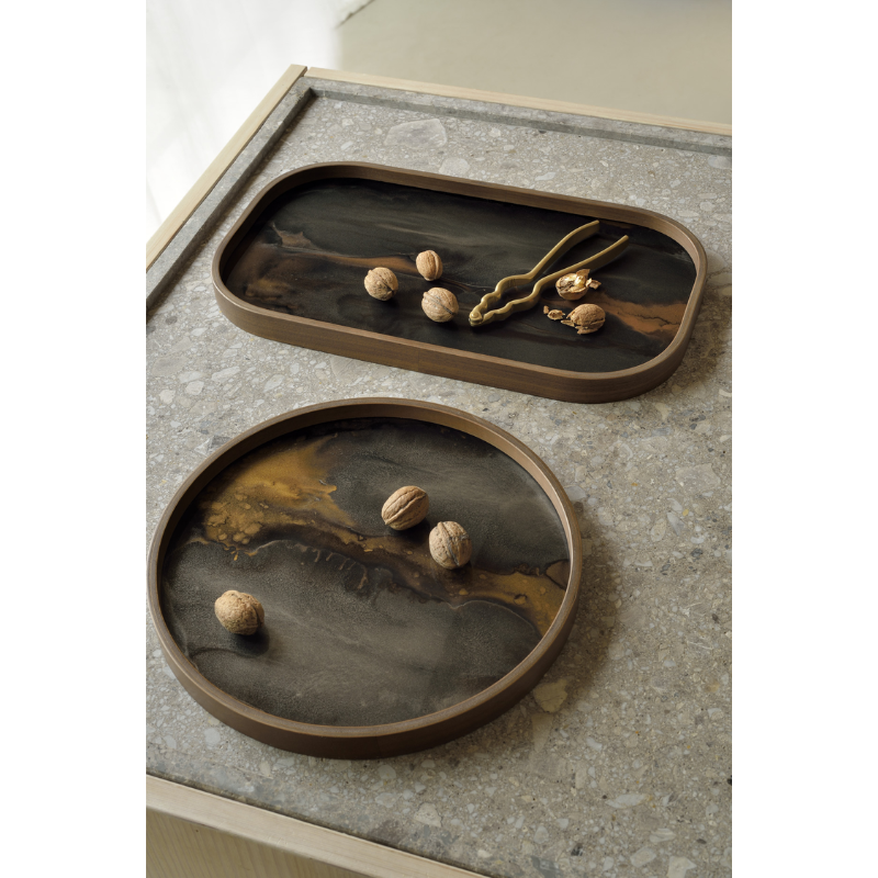 The bronze Organic Valet Tray from Ethnicraft in a family area.