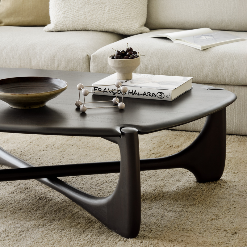 The Pebble PI Coffee Table from Ethnicraft in a living room.