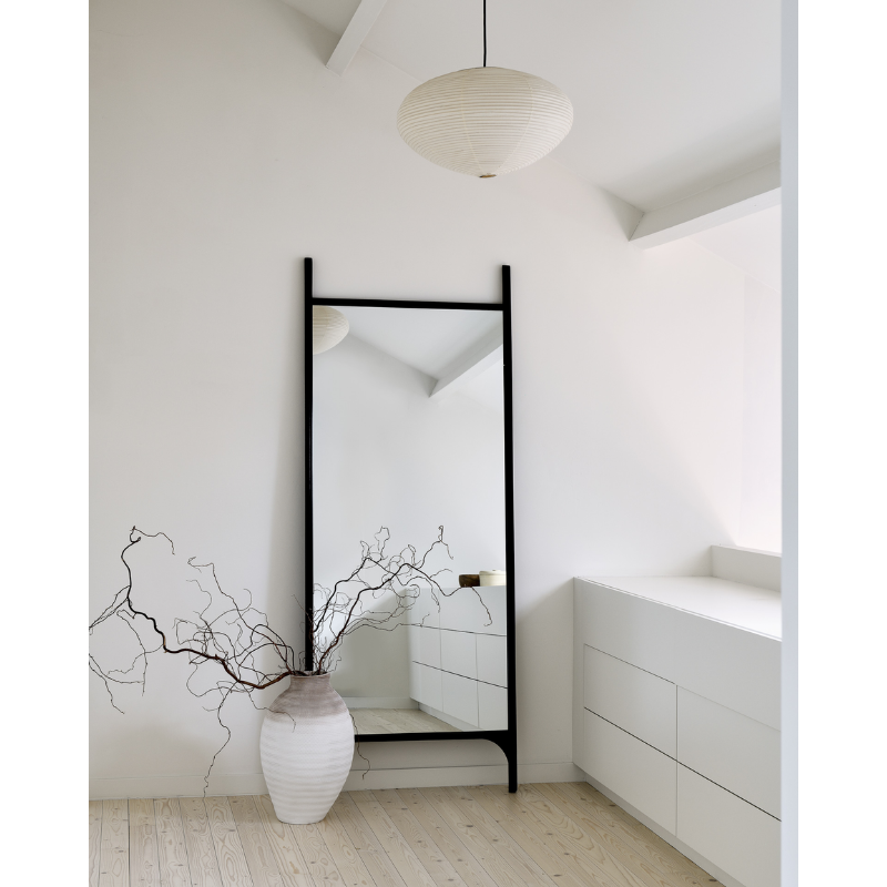 The full PI Floor Mirror from Ethnicraft in a living room.