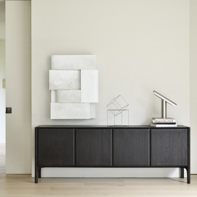 The PI Sideboard from Ethnicraft in dark brown teak in an office.
