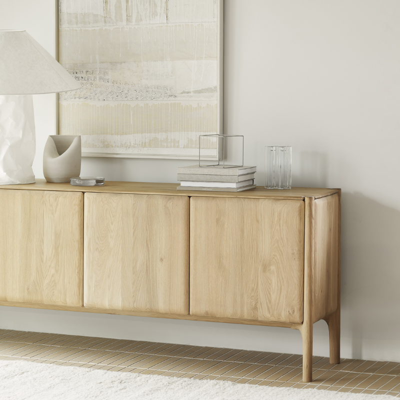 The PI Sideboard from Ethnicraft in oak in a lounge.