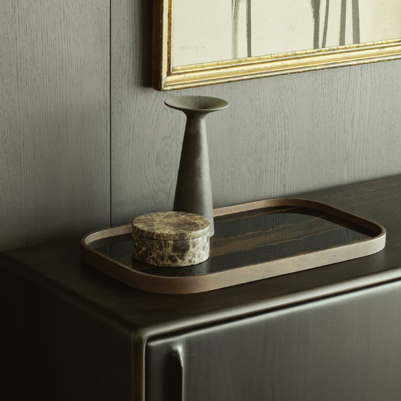 The Rectangular Organic Valet Tray Bronze from Ethnicraft in a living room on the desk.