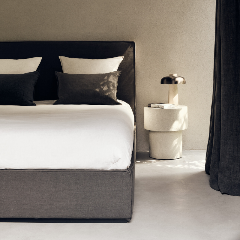 The Revive Bed from Ethnicraft in grey color in a bedroom.