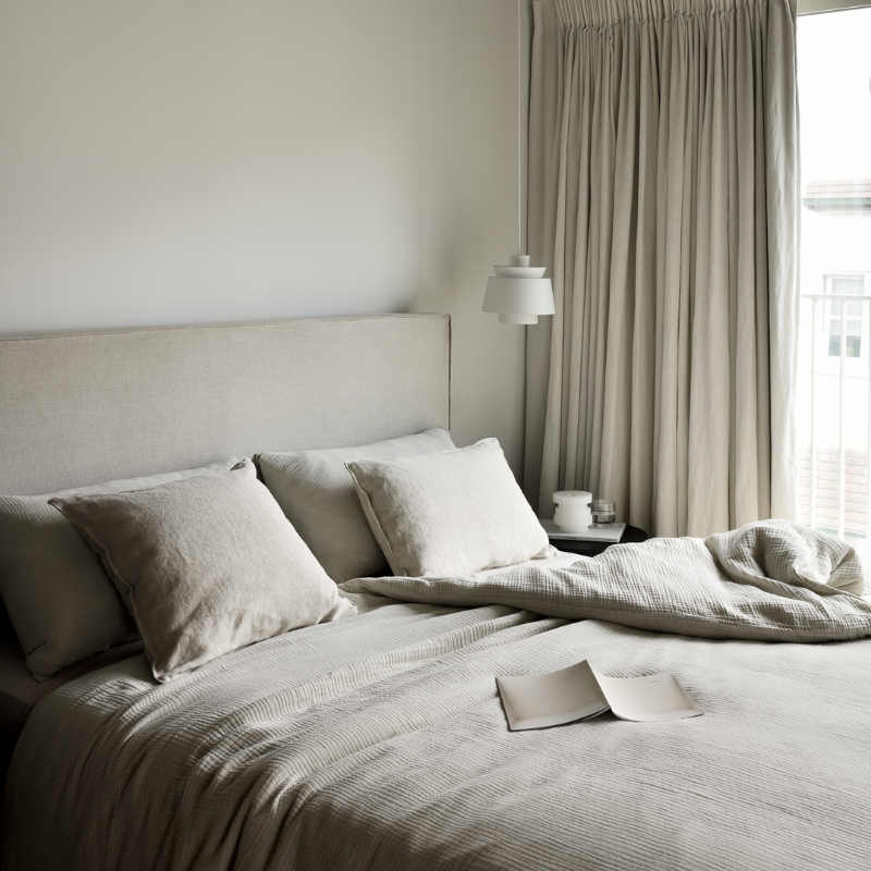 The Revive Bed from Ethnicraft in sand color in a bedroom.