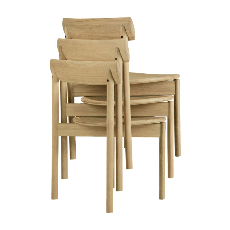 The Risu Dining Chair by Ethnicraft stacked in a group of three.