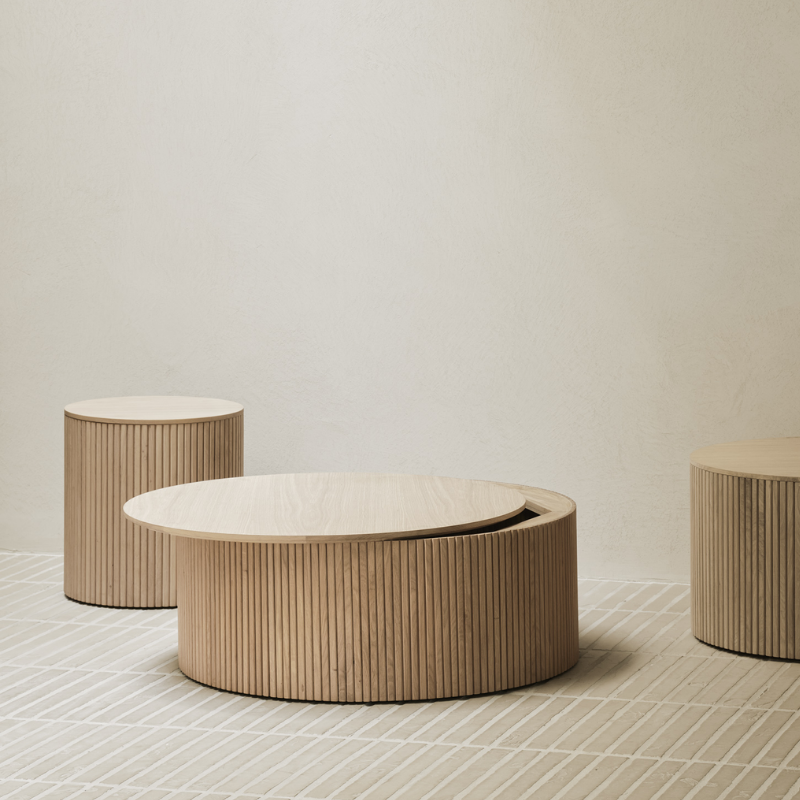 The 23.5 and 31.5 inch Roller Max Coffee Table Oak by Ethnicraft in a living room.