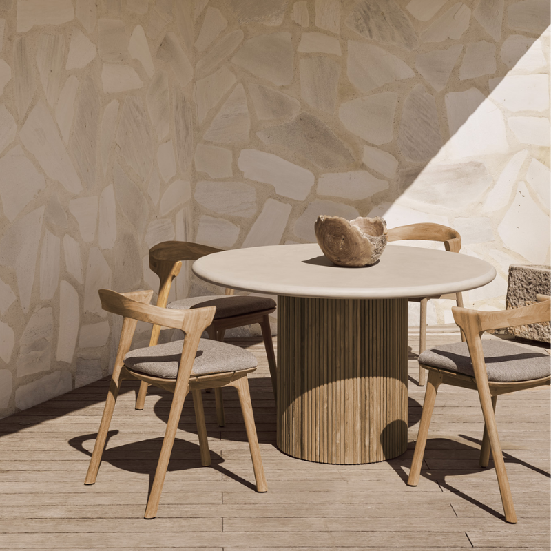 The Roller Max Outdoor Dining Table from Ethnicraft in an outdoor dining area.